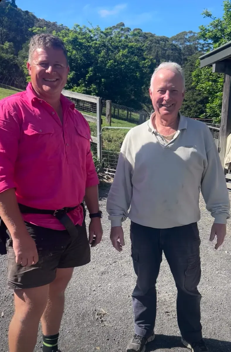 Coast Flow owner standing with a customer at a rural Far Meadow property near Berry after a roof clean, gutter clean and gutter guard install